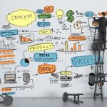 19063776 - businessman drawing color business strategy on wall