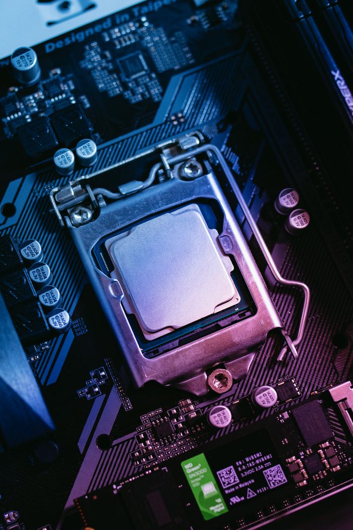 hero Detailed close-up of a computer motherboard highlighting the CPU socket with electronic components.